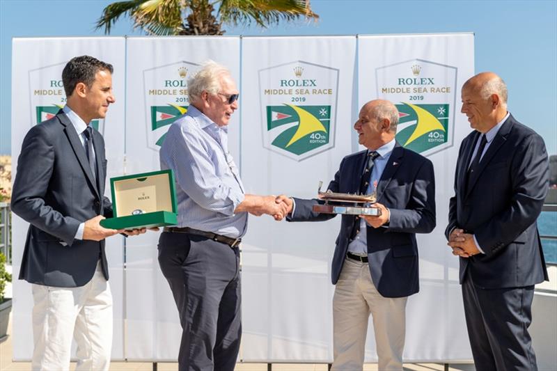 Royal Malta Yacht Club Commodore Godwin Zammit, presenting Rambler 88 Owner/ Skipper George David with the Line Honours Trophy - 2019 Rolex Middle Sea Race, day 4 - photo © Kurt Arrigo / Rolex