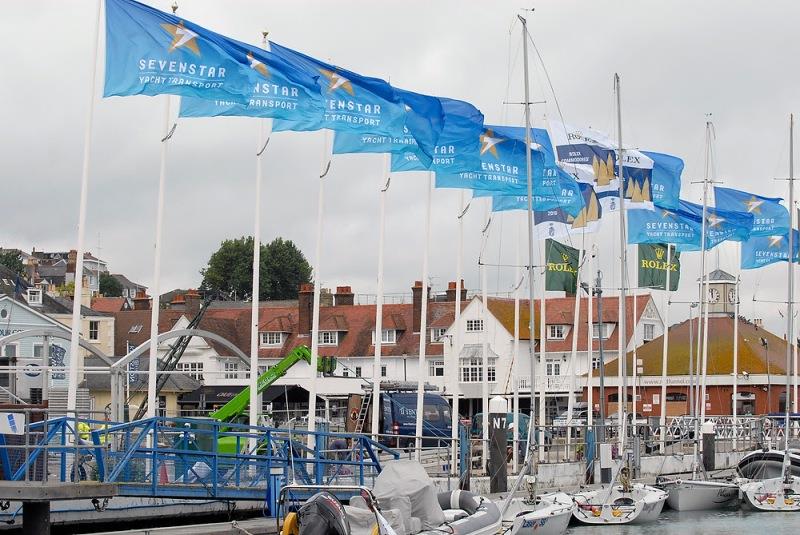 Creating a festival atmosphere before their epic non-stop race. Sevenstar Yacht transport flags flying high in Cowes Yacht Haven photo copyright Rick Tomlinson taken at Royal Ocean Racing Club