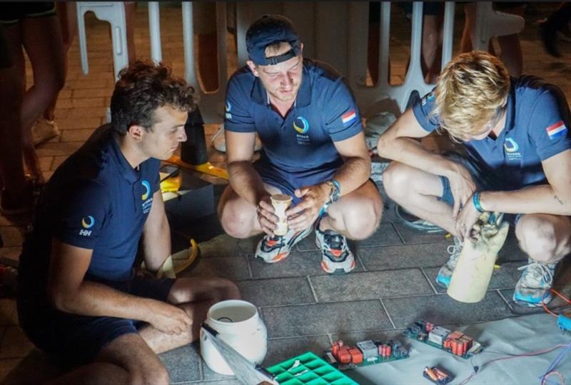 Team members investigate the damage and possible solutions. - photo © TU Delft Solar Boat Team