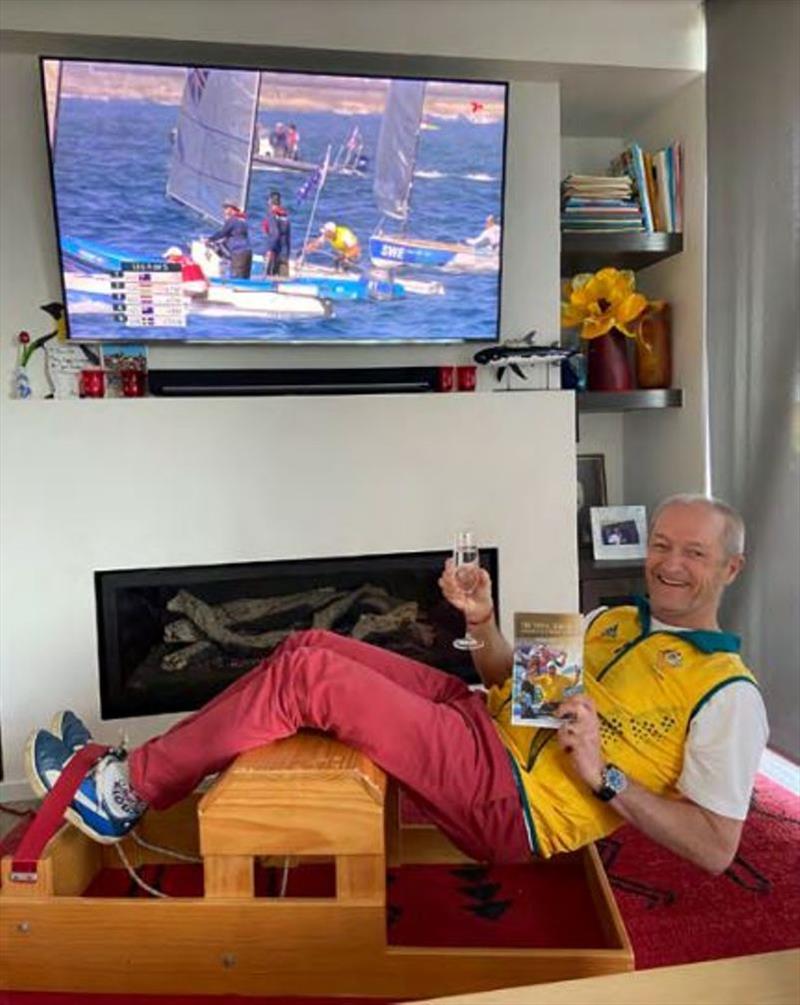 Hanging out watching the Olympics, noting champagne to celebrate Mat/Will gold, Finn Medal Race on screen with Jake leading, team vest, Victor's book for inspiration photo copyright Alistair Murray taken at 