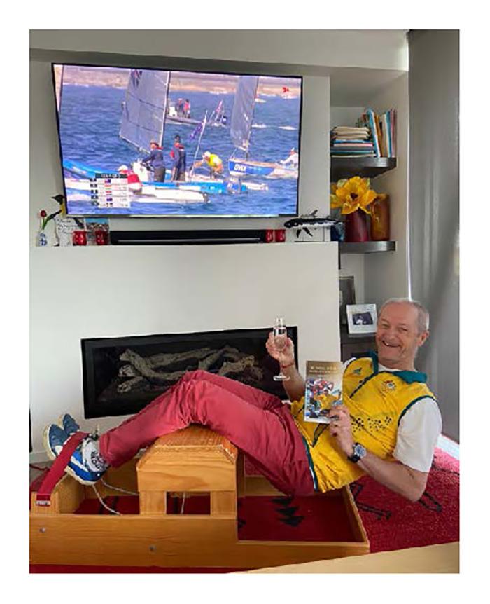 Hanging out watching the Olympics, noting champagne to celebrate Mat & Wil's gold. Jake leading the medal race on screen and Victor's book handy for inspiration photo copyright Australian Sailing Team taken at Australian Sailing