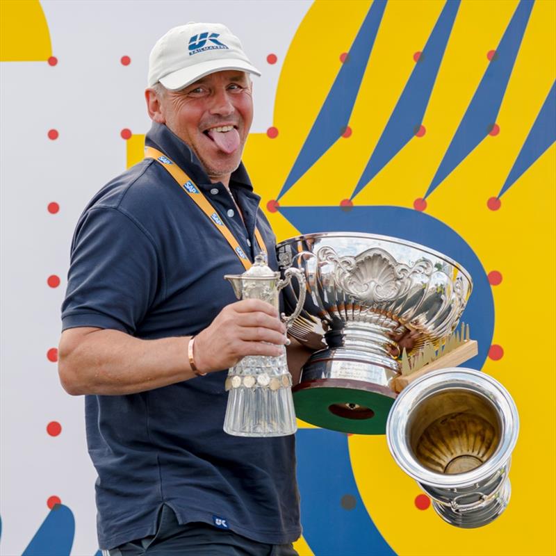 Mischievously, Denmark's Bo Petersen grins over a great deal of trophies for his OK Dinghy victory photo copyright Sascha Klahn taken at Kieler Yacht Club