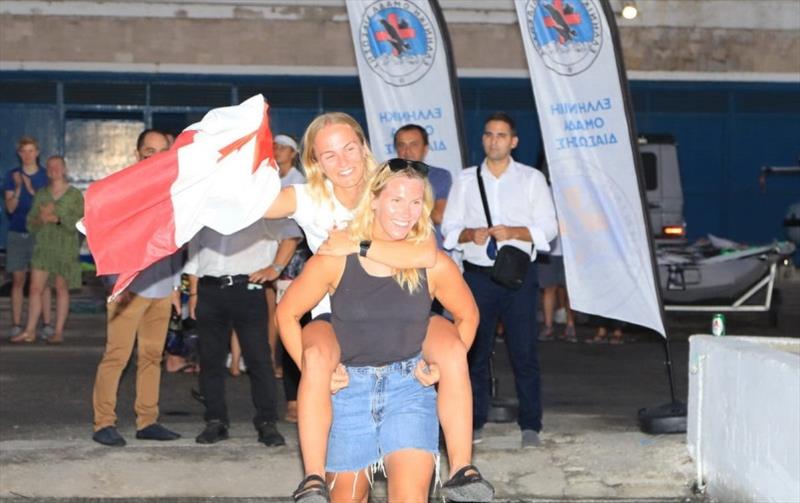 As if crews don't work hard enough during the week... Georgia carries Antonia onto the podium, literally. - photo © Nikos Pantis