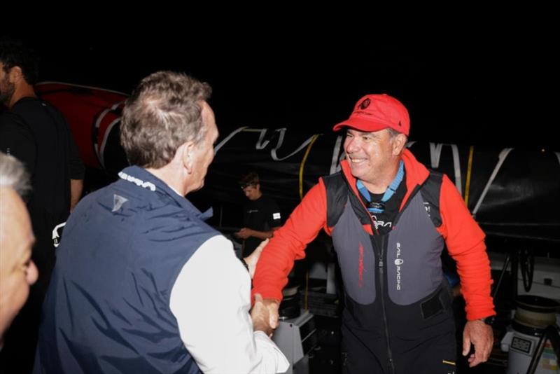 On the dock at Falmouth Marina, Antigua - RORC CEO Jeremy Wilton congratulates Mitch Booth, Skipper of Comanche photo copyright Arthur Daniel / RORC taken at Royal Ocean Racing Club