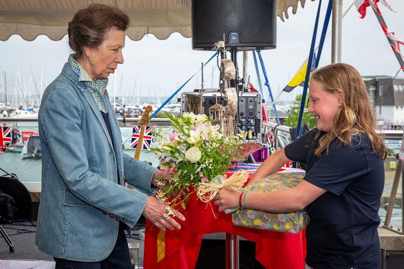 HRH The Princess Royal is presented with flowers and gifts by young RLymYC member Ruby Coster photo copyright Sportography taken at Royal Lymington Yacht Club
