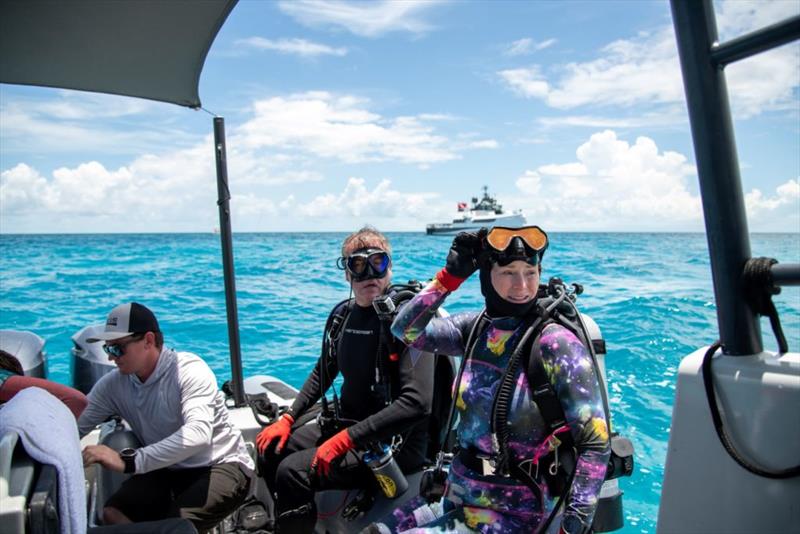 Gigi Allen prepares to dive with the Yacht Support 5009 AXIS in the background - photo © Damen Yachting