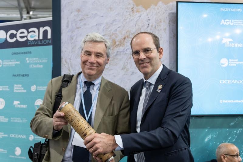 Richard Brisus, Race Chairman, The Ocean Race, passes the Nature's Baton to US Senator Sheldon Whitehouse at the Ocean Pavilion at COP27 photo copyright Cherie Bridges / The Ocean Race taken at 