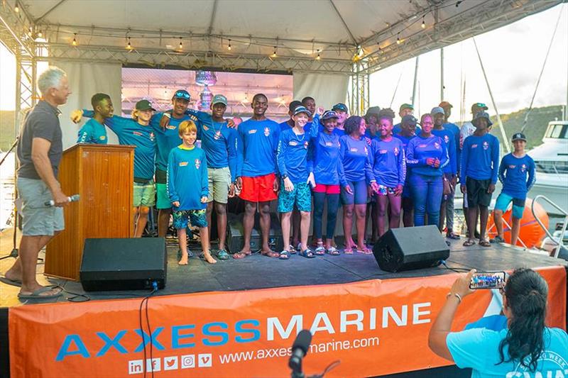 Proud young sailors on the stage at the Axxess Marine Y2K Race Day Prize Giving at Antigua Sailing Week 2023 photo copyright Visual Echo taken at Antigua Yacht Club