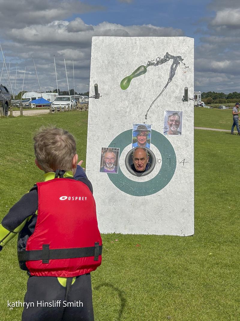 The Commodore being water bombed by a youngster during the NCSC August Bank Holiday Games 2023 photo copyright Katheryn Hinsliff-Smith taken at Notts County Sailing Club