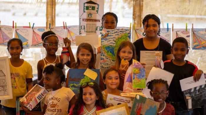 Young artists from local schools proudly show their Regatta artwork and prizes at the Annual Regatta Art Competition hosted by the Sint Maarten Yacht Club photo copyright Digital Island taken at Sint Maarten Yacht Club