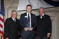 © Guy Gurney Peter Gibbons-Neff Jr., receives the 2025 Charles H. Vilas Literary Prize, with the incoming CCA Commodore Chace Anderson, left, and outgoing CCA Commodore Jay Gowell © Guy Gurney