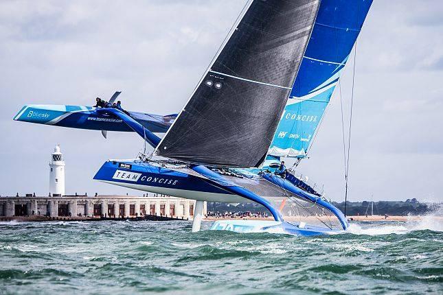 Concise 10 powering past Hurst Castle photo copyright Ollie Mellor taken at Royal Ocean Racing Club and featuring the MOD70 class