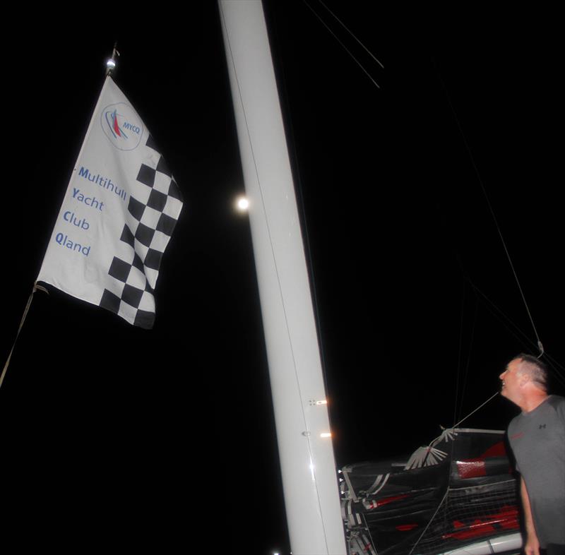 Raising the line honours flag - 55th Brisbane to Gladstone Multihull Yacht Race 2019 photo copyright Chris Dewar taken at  and featuring the MOD70 class