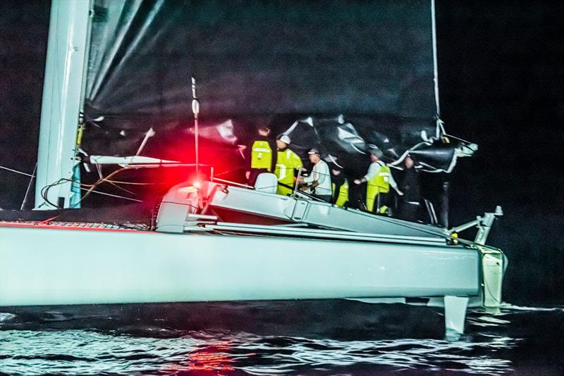 After the finish, the crew of Argo stands in the trimaran's relatively small cockpit. Overhead, the two reefs in its mainsail testify to the crew's efforts to use less sail area to avoid overpowering the boat.  - photo © Chris Burville 