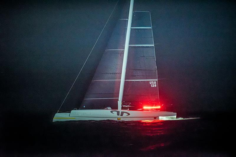 On its final approach to the St. David's Lighthouse finish, late Saturday evening, the MOD 70 trimaran Argo shows its sleek lines and black sails made of carbon. The time-lapse photo turns the port navigation light into a red streak photo copyright Chris Burville taken at Royal Bermuda Yacht Club and featuring the MOD70 class