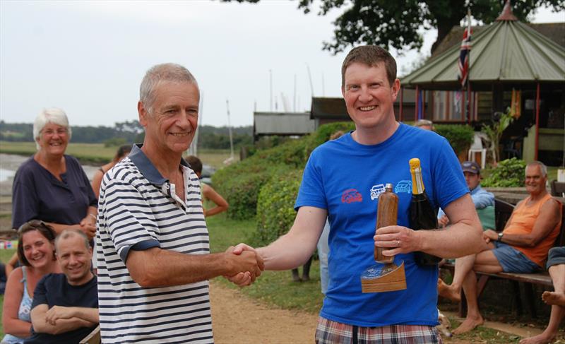 Champion Bernard Kufluk collects his trophy from Ian Videlo during the 2019 Bottle Boat Championship at Waldringfield photo copyright Roger Stollery taken at Waldringfield Sailing Club and featuring the Model Yachting class