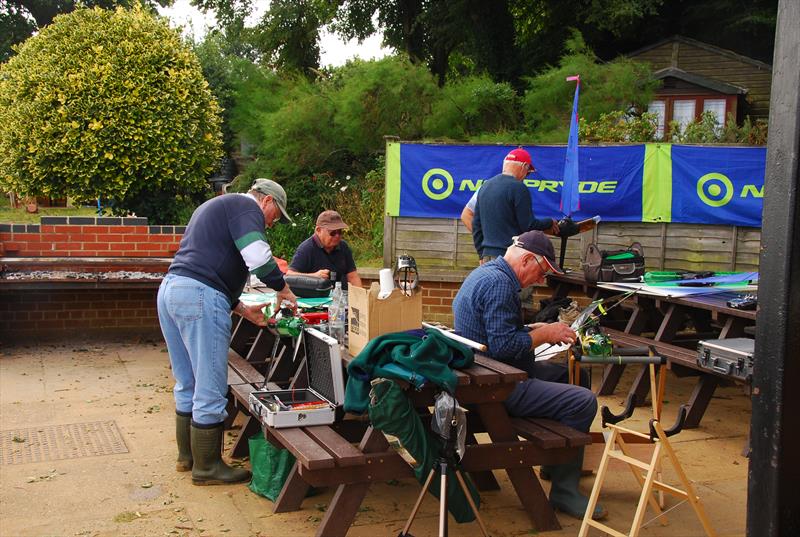 Maintenance work during a break at the 2019 Bottle Boat Championship at Waldringfield photo copyright Roger Stollery taken at Waldringfield Sailing Club and featuring the Model Yachting class