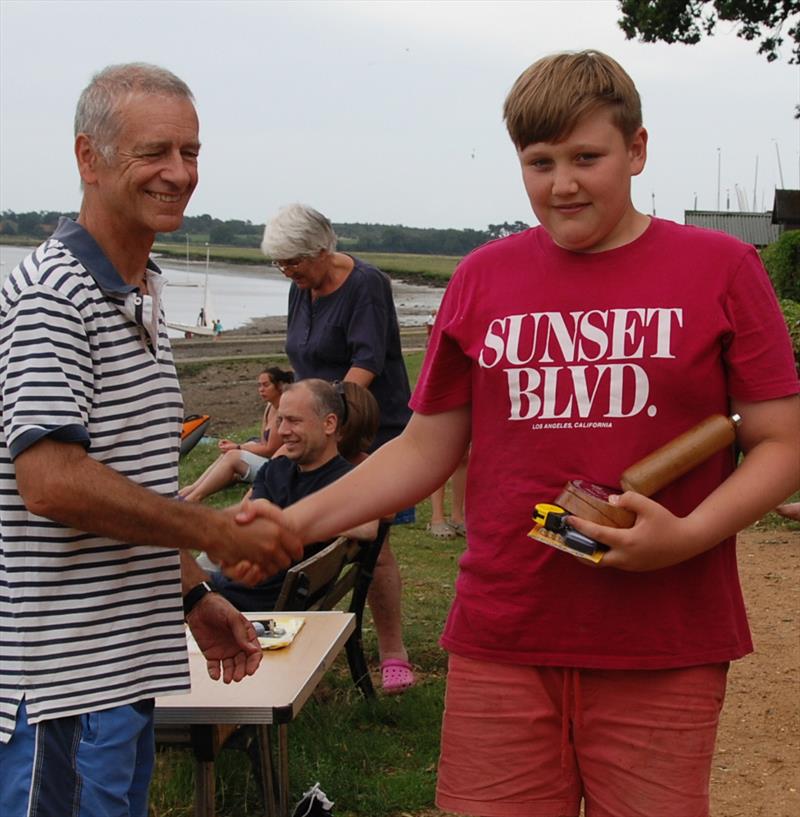 Joc Gwen collects the junior championship trophy and prize during the 2019 Bottle Boat Championship at Waldringfield photo copyright Roger Stollery taken at Waldringfield Sailing Club and featuring the Model Yachting class