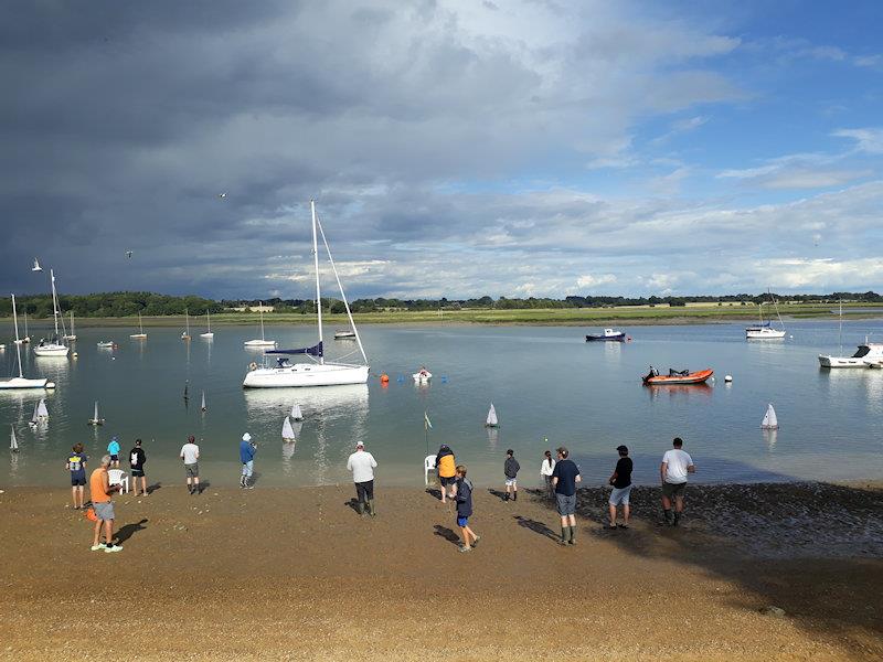 Competitors on the beach control area at the start of Race 14 in the very variable NW reaching/beating winds in the shadow of the cliff behind photo copyright Linda Price taken at Waldringfield Sailing Club and featuring the Model Yachting class