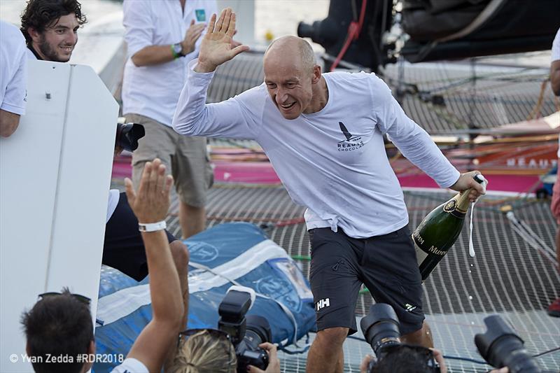 Armel Tripon celebrating at the dock in Guadeloupe - Route du Rhum-Destination Guadeloupe photo copyright Yvan Zedda taken at  and featuring the Multi 50 class