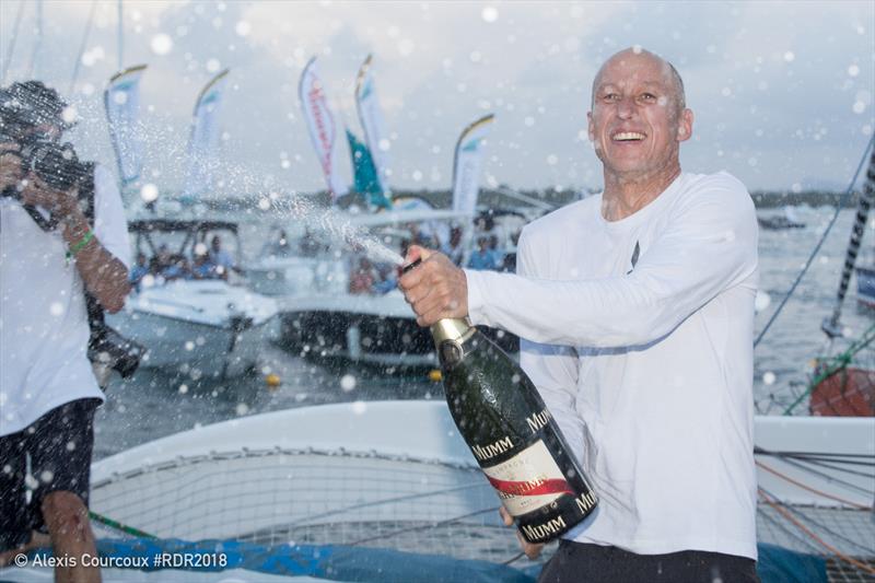 Armel Tripon enjoying his champagne moment after finishing first in the Multi50 class - Route du Rhum-Destination Guadeloupe photo copyright Alexis Courcou taken at  and featuring the Multi 50 class