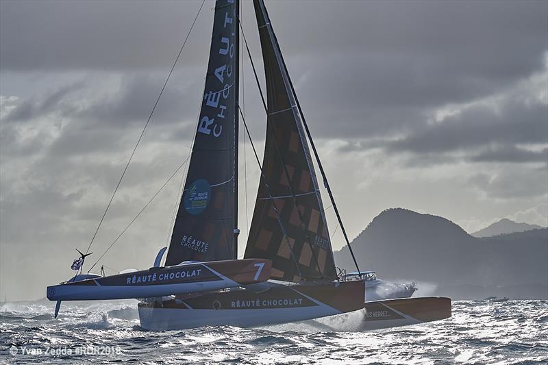 The trimaran Réauté Chocolat with the island of Guadeloupe in the background as he races to the finish line - Route du Rhum-Destination Guadeloupe photo copyright Yvan Zedd taken at  and featuring the Multi 50 class