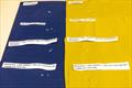 Previous DWR face fabric (left, blue) and PFC-free DWR face fabric (right, yellow) with water droplets just applied