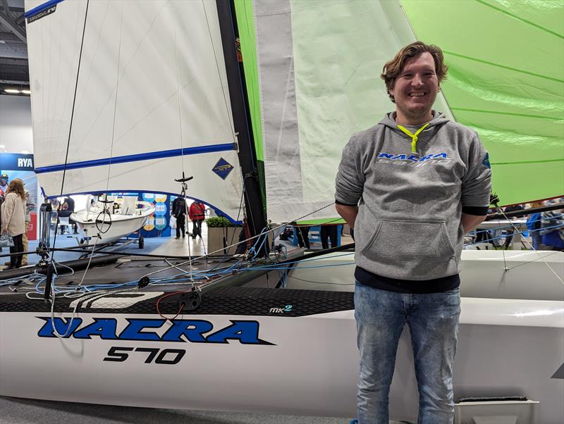 Rogier Voetelink, Sales & Marketing Manager at Nacra Sailing, in front of the Nacra 570 at the RYA Dinghy & Watersports Show 2024 photo copyright Mark Jardine taken at RYA Dinghy Show and featuring the Nacra class