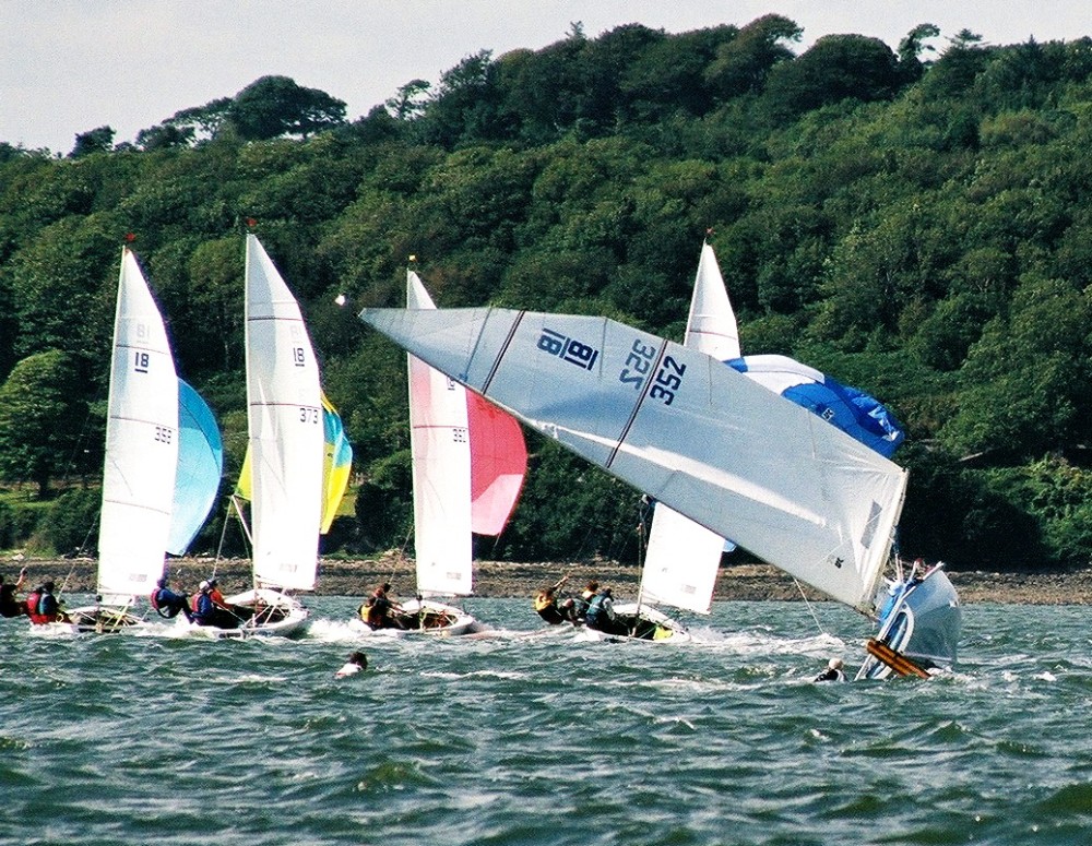 Dom Long going for a dip sailing his National 18 in Cork Harbour photo copyright Susie Slack taken at Royal Cork Yacht Club and featuring the National 18 class
