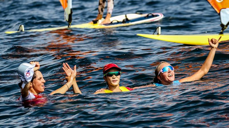 The three RS:X Womans Medal winners celebrate soon after the race finish - Tokyo2020 - Day 7- July, 31, - Enoshima, Japan photo copyright Richard Gladwell - Sail-World.com/nz taken at  and featuring the RS:X class