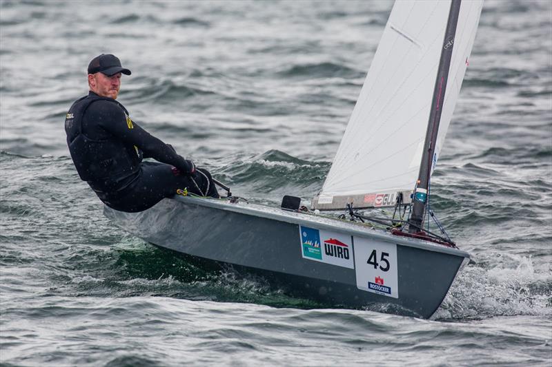 Charlie Cumbley on day 2 of the OK Dinghy World Championship photo copyright Robert Deaves taken at  and featuring the OK class
