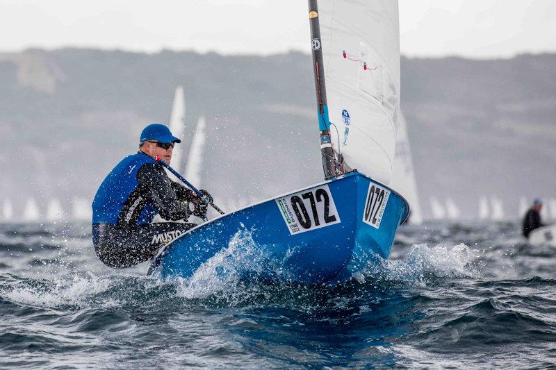 OK Dinghy Worlds Day 1 - Russ Clark, GBR photo copyright Robert Deaves / www.robertdeaves.uk taken at Lyme Regis Sailing Club and featuring the OK class