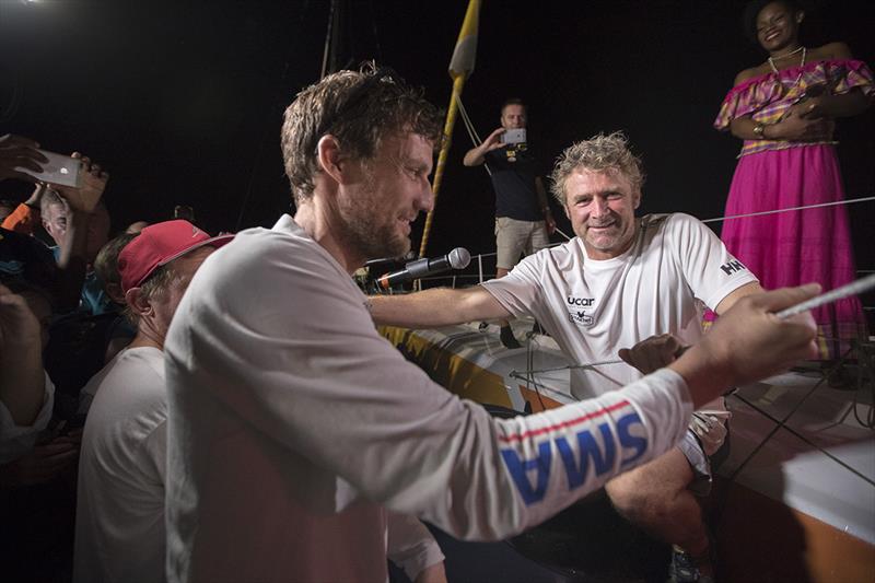 Yann Eliès at the dock in Guadeloupe with winner, Paul Meilhat after a great battle on the water - 2018 Route du Rhum-Destination Guadeloupe photo copyright Alexis Courcoux taken at  and featuring the IMOCA class