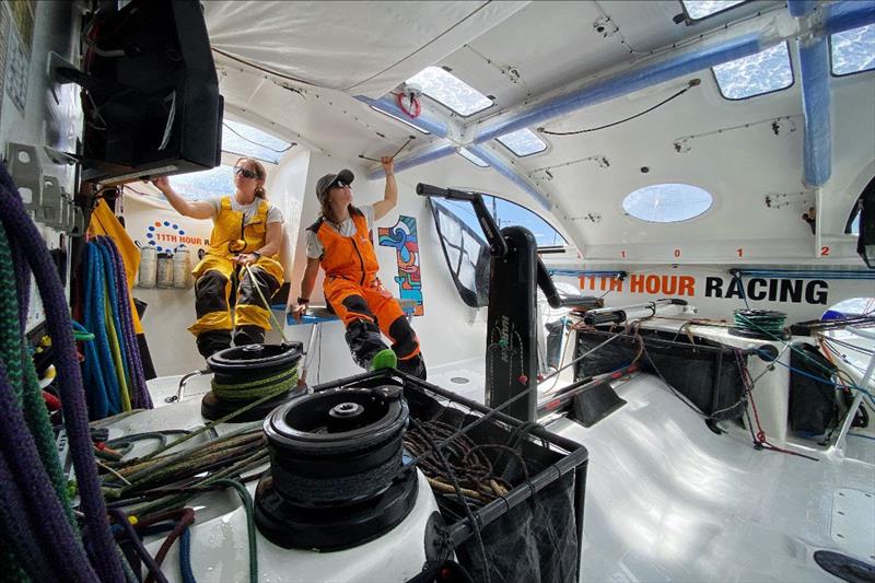 Aboard the new IMOCA 60 Malama, regular crewmember Justine Mettraux and guest crew Elena Hight stand watch as seawater regularly washes across the observation windows and openings above - photo © Amory Ross/11th Hour Racing photo