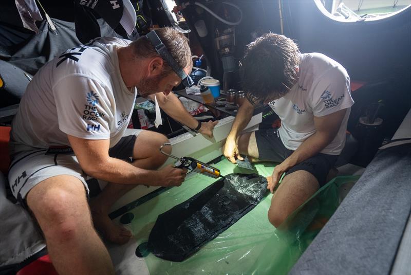 6 February 2023, Leg 2, Day 13 onboard GUYOT environnement - Team Europe. Robert Stanjek and Sébastien Simon fixing a hole on the A3 with a patch and sikaflex - photo © Charles Drapeau / GUYOT environnement - Team Europe