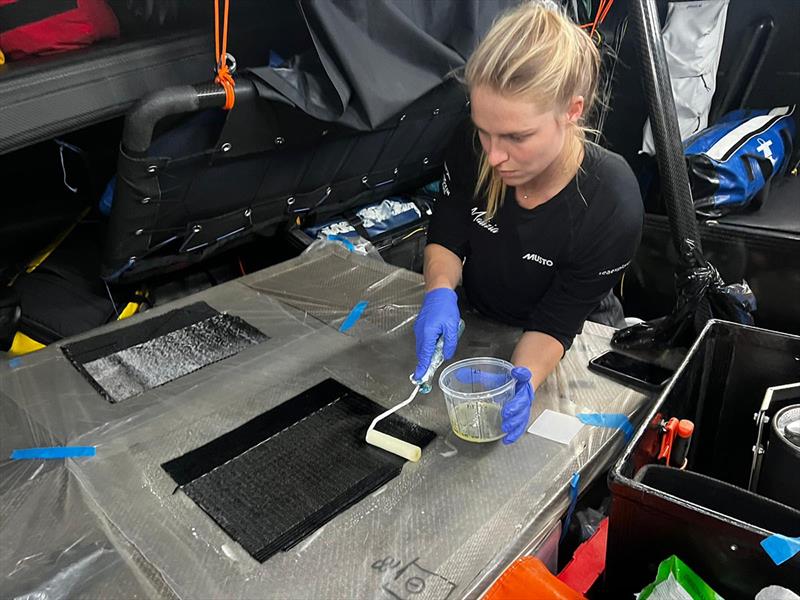 Image of Rosalin Kuiper preparing the carbon laminate stacks for Will Harris to apply to the mast photo copyright Antoine Auriol taken at  and featuring the IMOCA class