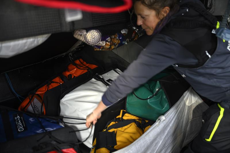 The Ocean Race 2022-23 Leg 3 onboard Biotherm. Sam Davies sorting out bags photo copyright Ronan Gladu / Biotherm taken at  and featuring the IMOCA class