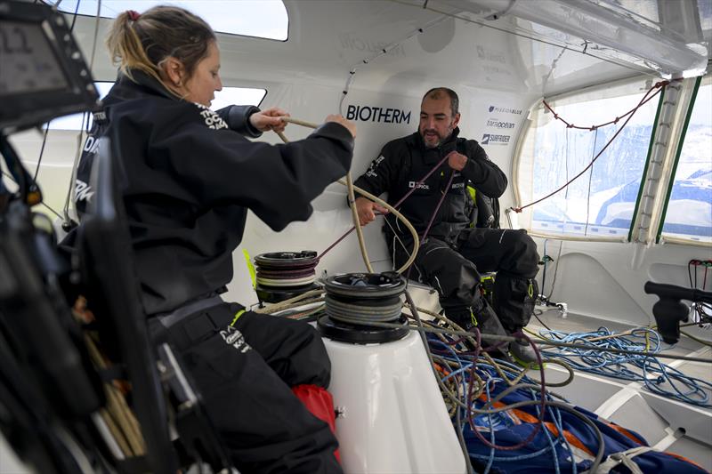 The Ocean Race 2022-23 Leg 3, Day 27 onboard Biotherm. Sam Davies and Damien Seguin organising the cockpit photo copyright Ronan Gladu / Biotherm / The Ocean Race taken at  and featuring the IMOCA class