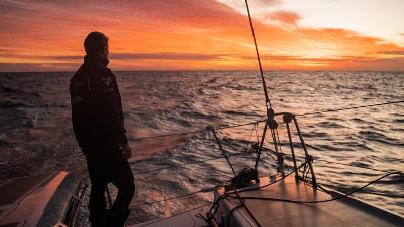 The Ocean Race 2022-23 - 30 March 2023, Leg 3 Day 32 onboard Team Malizia. Will Harris enjoys the beauty of the Atlantic sunset on deck photo copyright Antoine Auriol / Team Malizia / The Ocean Race taken at  and featuring the IMOCA class