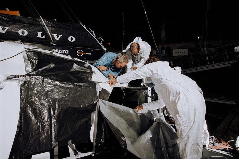 The 11th Hour Racing Team continues repairs after a collision during the start of Leg 7 photo copyright Pierre Bouras taken at New York Yacht Club and featuring the IMOCA class