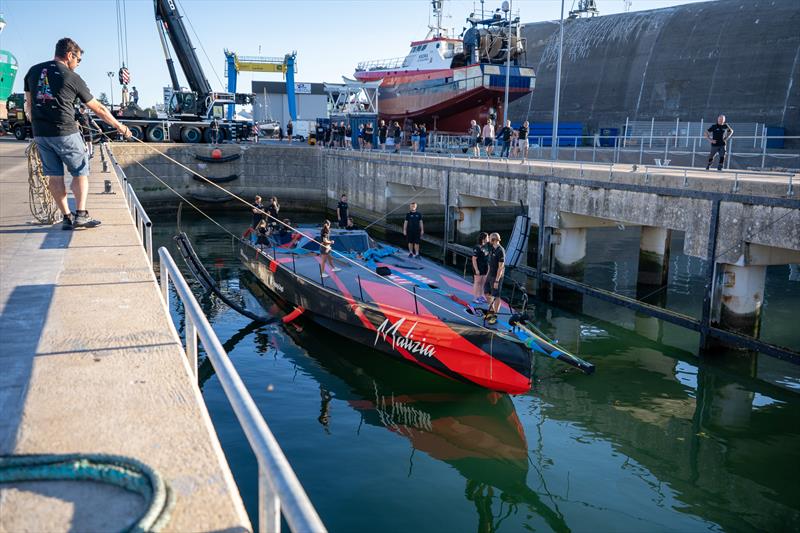 Malizia 4 and the team, shortly after her very first splash early this morning photo copyright Marie Lefloch / Team Malizia taken at  and featuring the IMOCA class
