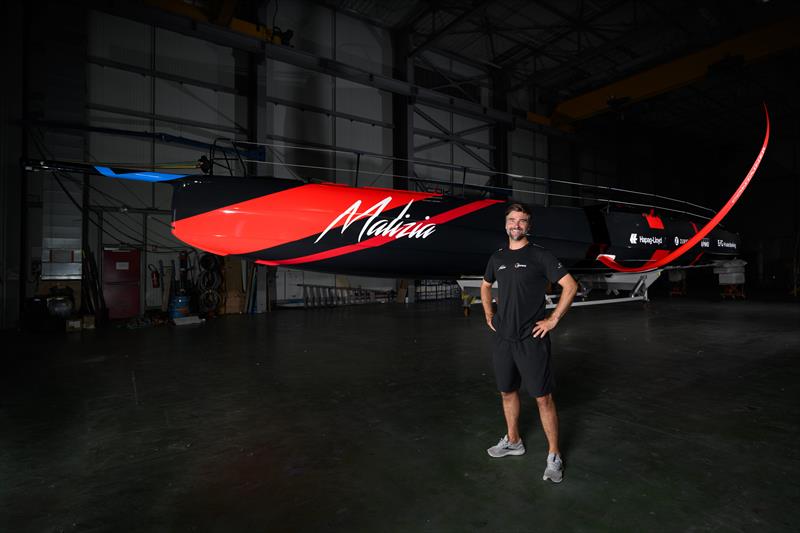 Boris Herrmann standing in front of Malizia 4 the day before she was rolled out of the hangar for the first time photo copyright Ricardo Pinto / Team Malizia taken at  and featuring the IMOCA class