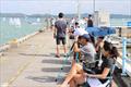 Parents braved the heat along the breakwater to watch their children race - Raffles Marina Optimist Regatta 2022 © Raffles Marina