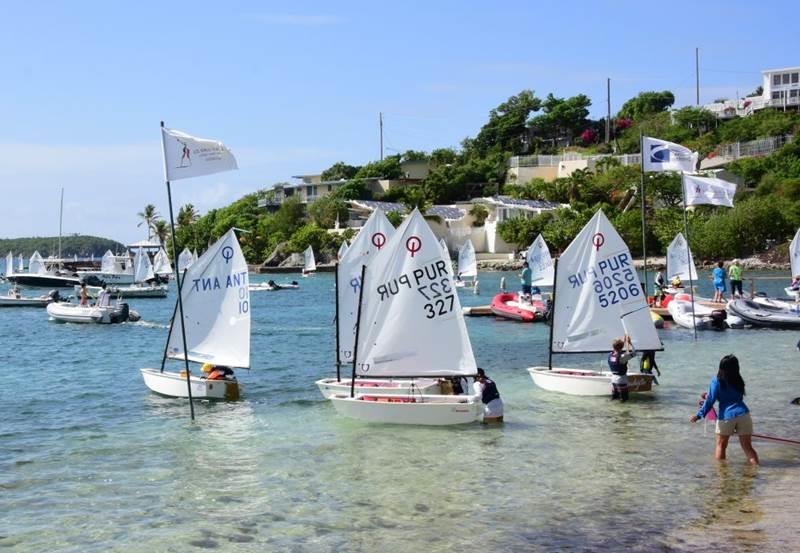 Optimist sailors launching from the beach in front of the St. Thomas Yacht Club for the 2019 International Optimist Regatta photo copyright Dean Barnes taken at St. Thomas Yacht Club and featuring the Optimist class