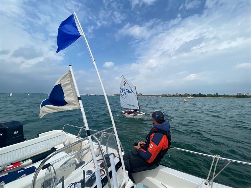 Parkstone Optimist Open Regatta fleet winner Jonny Rogers crossing the finish line - photo © Roger Hakes