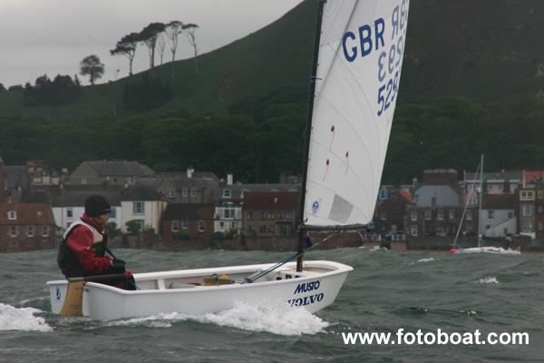 Iain Sword sails under a threatening sky photo copyright Alan Henderson / www.fotoboat.com taken at East Lothian Yacht Club and featuring the Optimist class