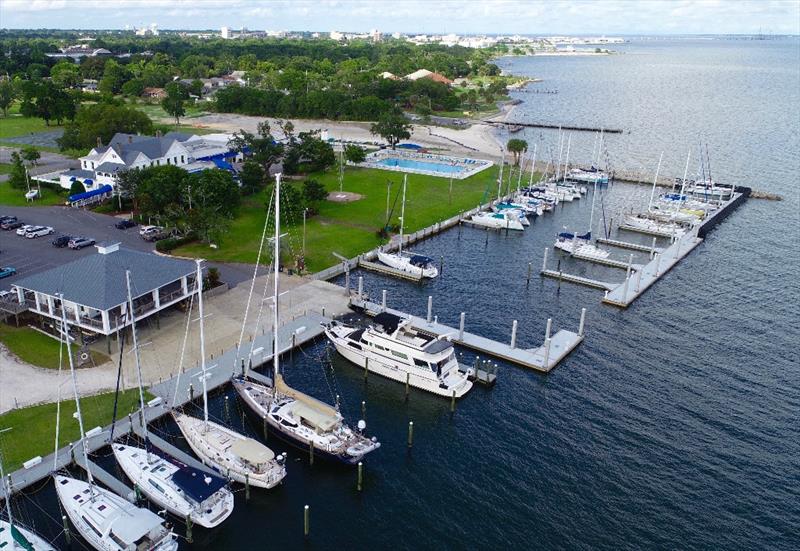 Pensacola Yacht Club is proud to host its third set of Optimist National Championship regattas. The Watson Sailing Center (L), the clubhouse and world's favorite bar, the pool and beach— all 22 acres- will be bustling with young sailors for the 8-day - photo © Talbot Wilson