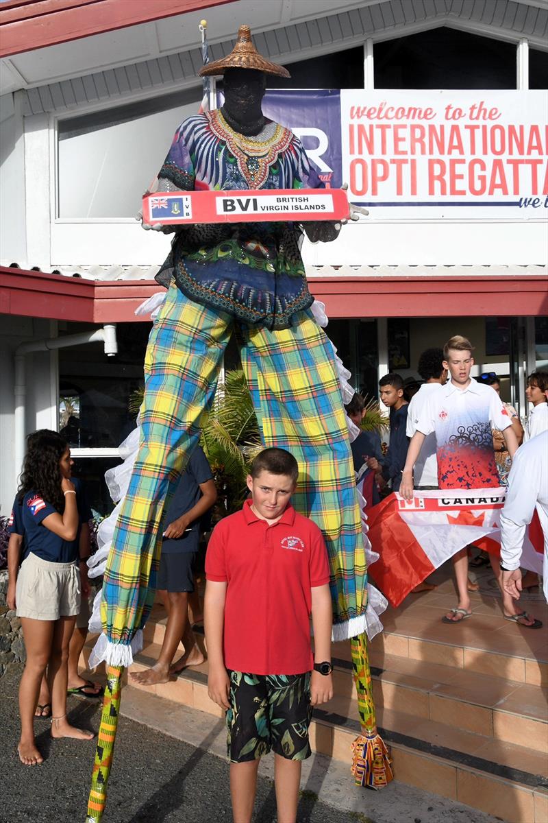 The BVI's Samuel Allen stands with a Mocko Jumbie (stilt-walker) in front of the St. Thomas Yacht Club photo copyright Dean Barnes taken at St. Thomas Yacht Club and featuring the Optimist class