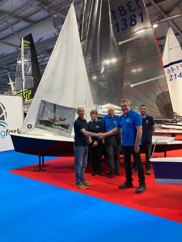 Rob Cage (CraftInsure) and Peter Frith (Chairman, Osprey Class Association) shake on the agreement at the 2022 RYA Dinghy & Watersports Show photo copyright Osprey Class Association taken at RYA Dinghy Show and featuring the Osprey class