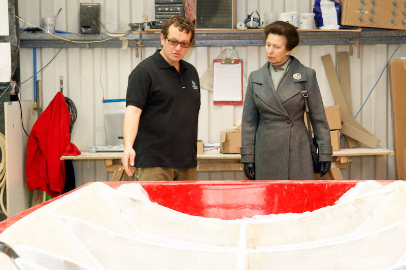 Chris Turner, Managing Director of Ovington Boats, explains the laminating process to Princess Anne photo copyright Charles Glover taken at  and featuring the  class